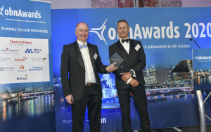 Domainex CEO Tom Mander collecting Best CRO award at OBN awards
