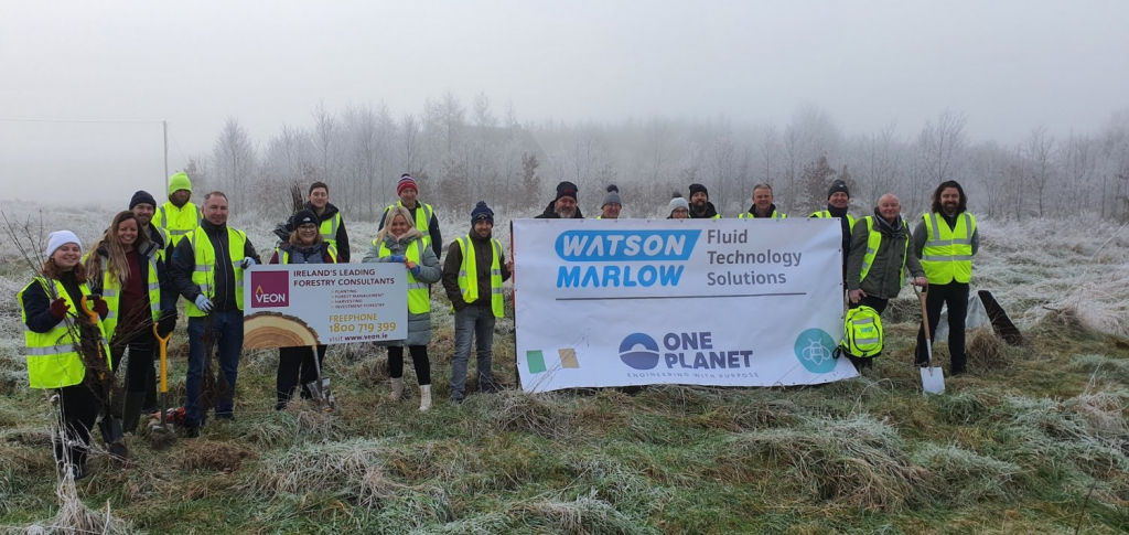 Group in high vis jackets holding two banners, one showing the Watson and Marlow logo and the second with the VEON logo
