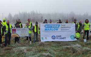 Group in high vis jackets holding two banners, one showing the Watson and Marlow logo and the second with the VEON logo